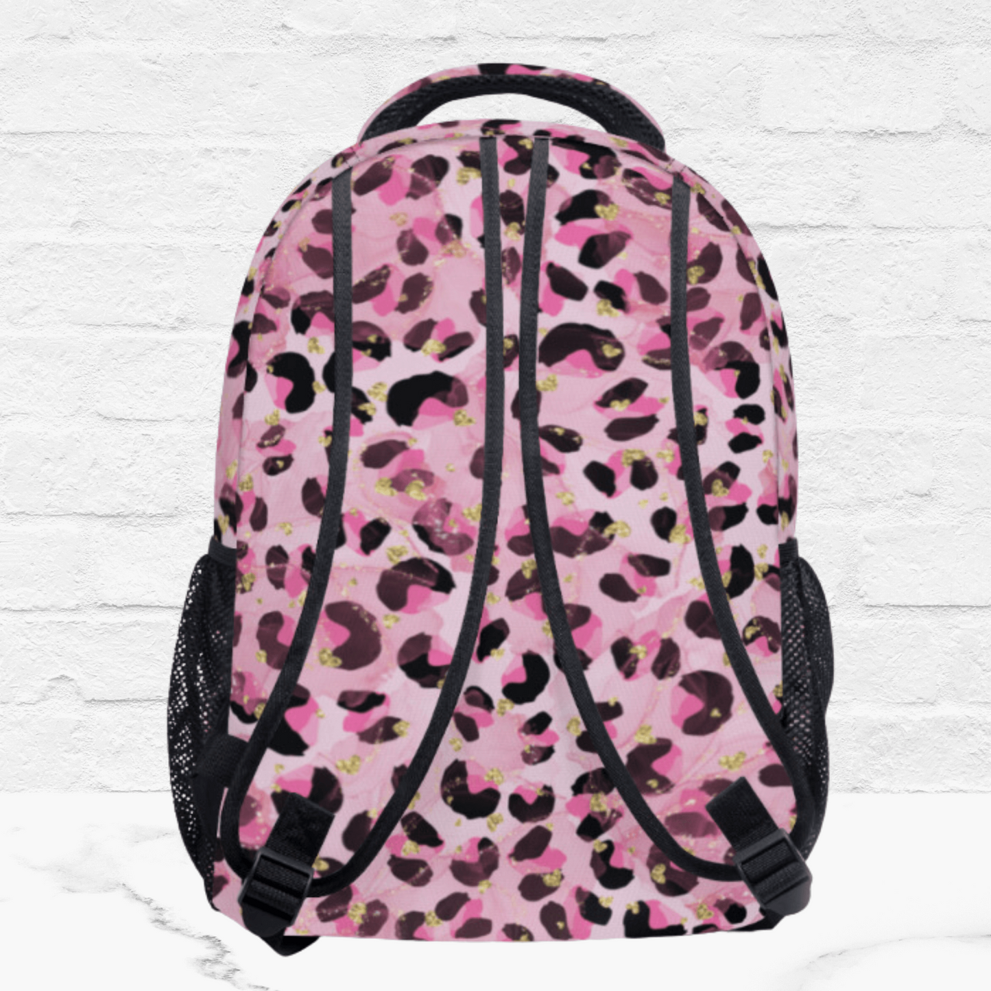 The back side of the pink backpack for her shows the padded shoulder straps in the pink pattern.