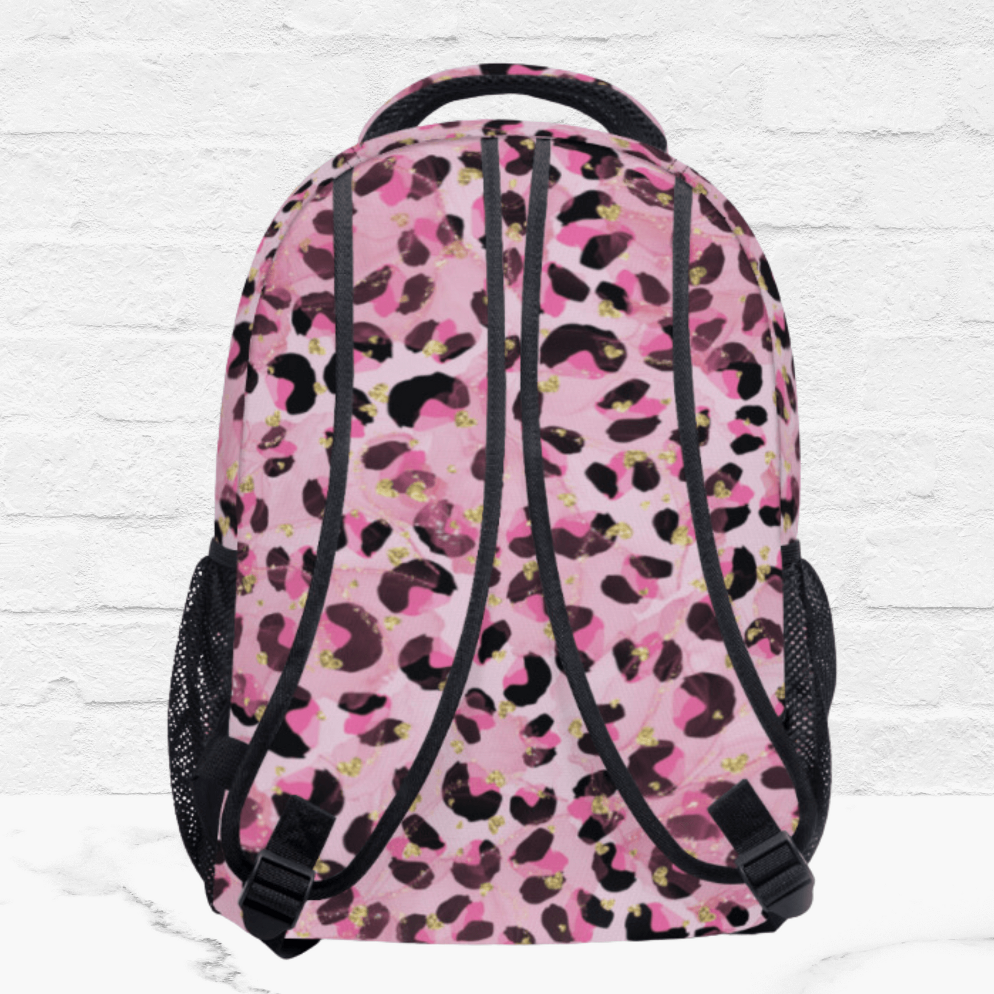 The back side of the pink backpack for her shows the padded shoulder straps in the pink pattern.