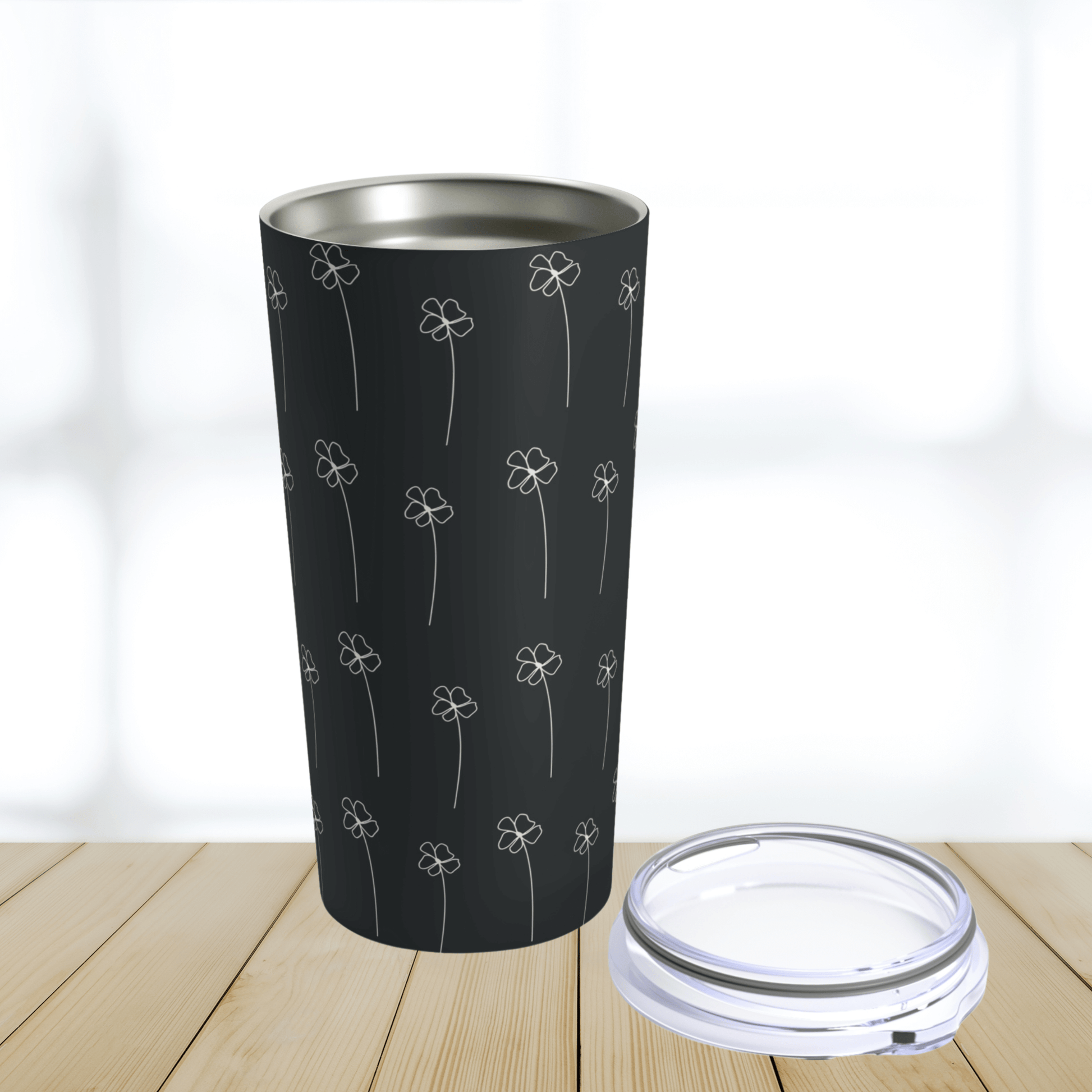 This tumbler is the perfect to go coffee mug and is shown with the lid off next to it.