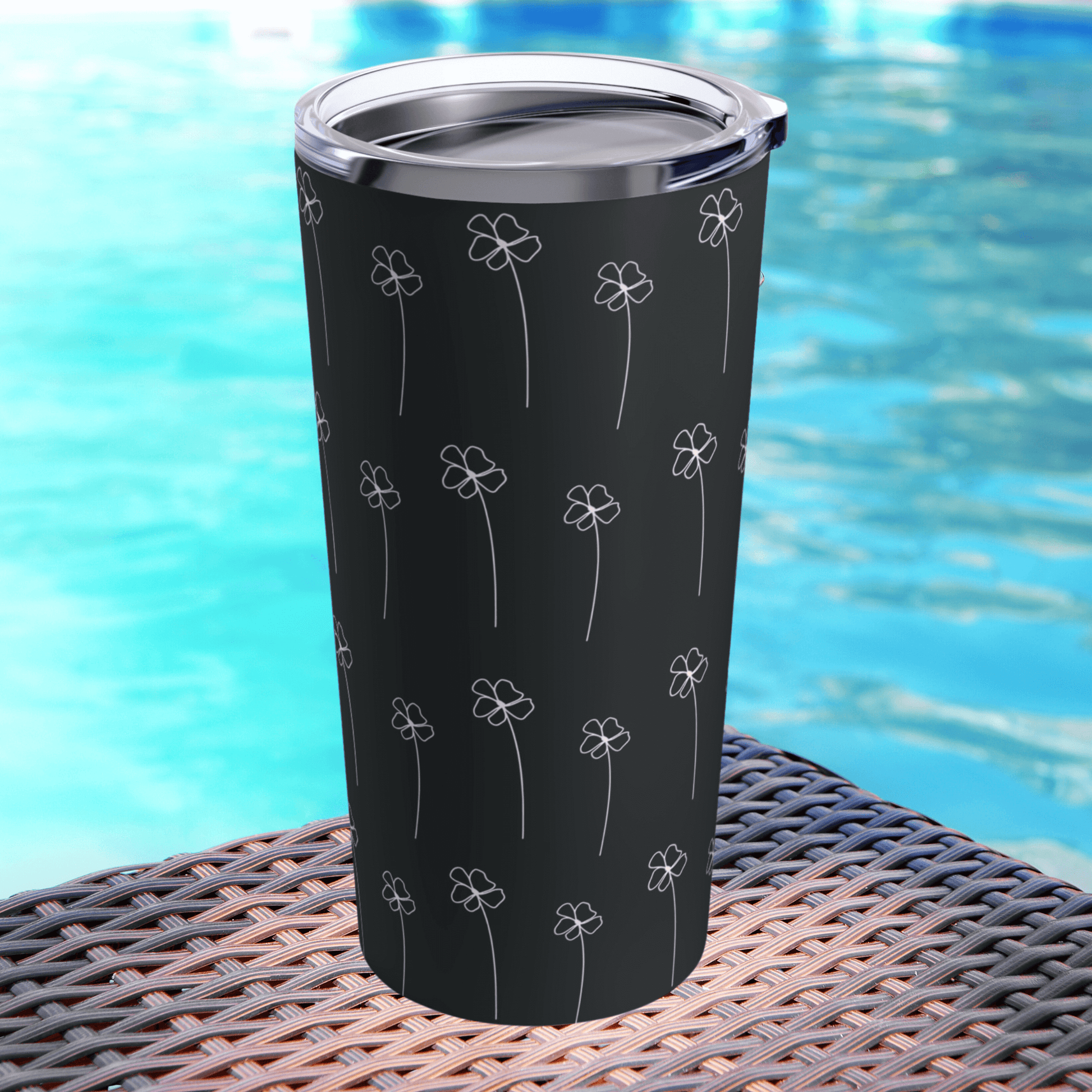 Our black tumbler cup is next to a pool and shows the glossy finish.