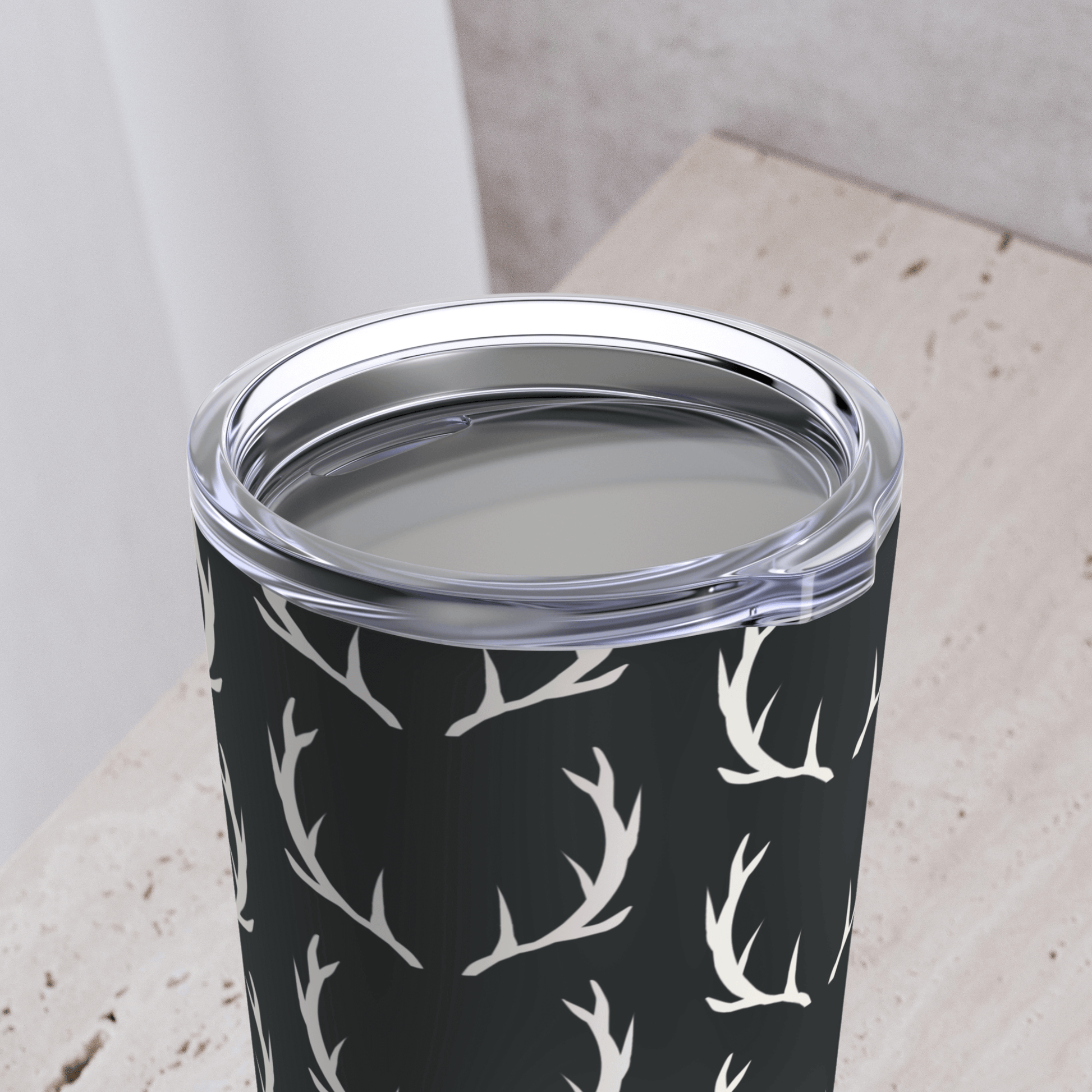 up close view shows the lid on our deer hunting tumbler for men. The lid is clear plastic.