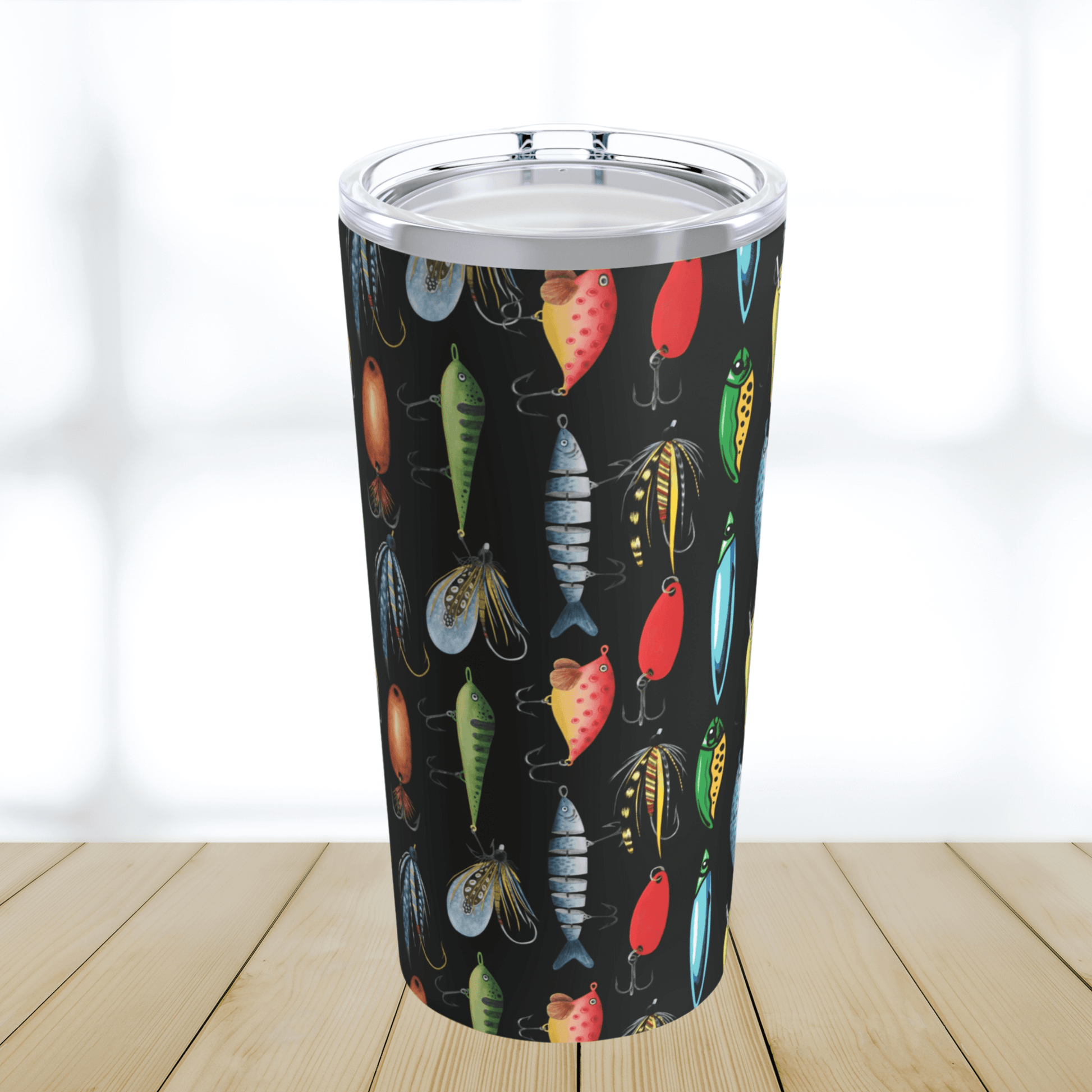 Our fishing lure tumbler cup has a black background and colorful fishing lures in greens blues reds and silver colors.