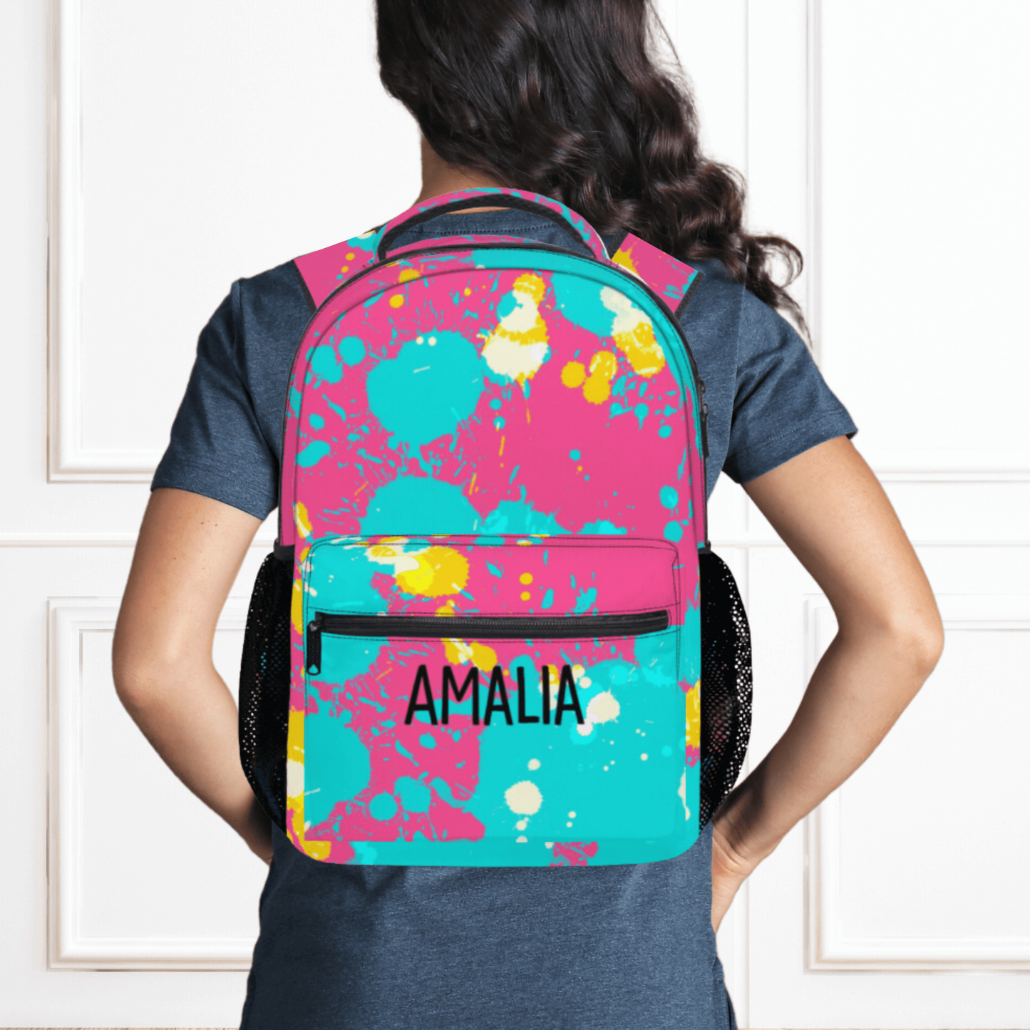 Our pink paint splatter backpack shown wearing the backpack on a model.