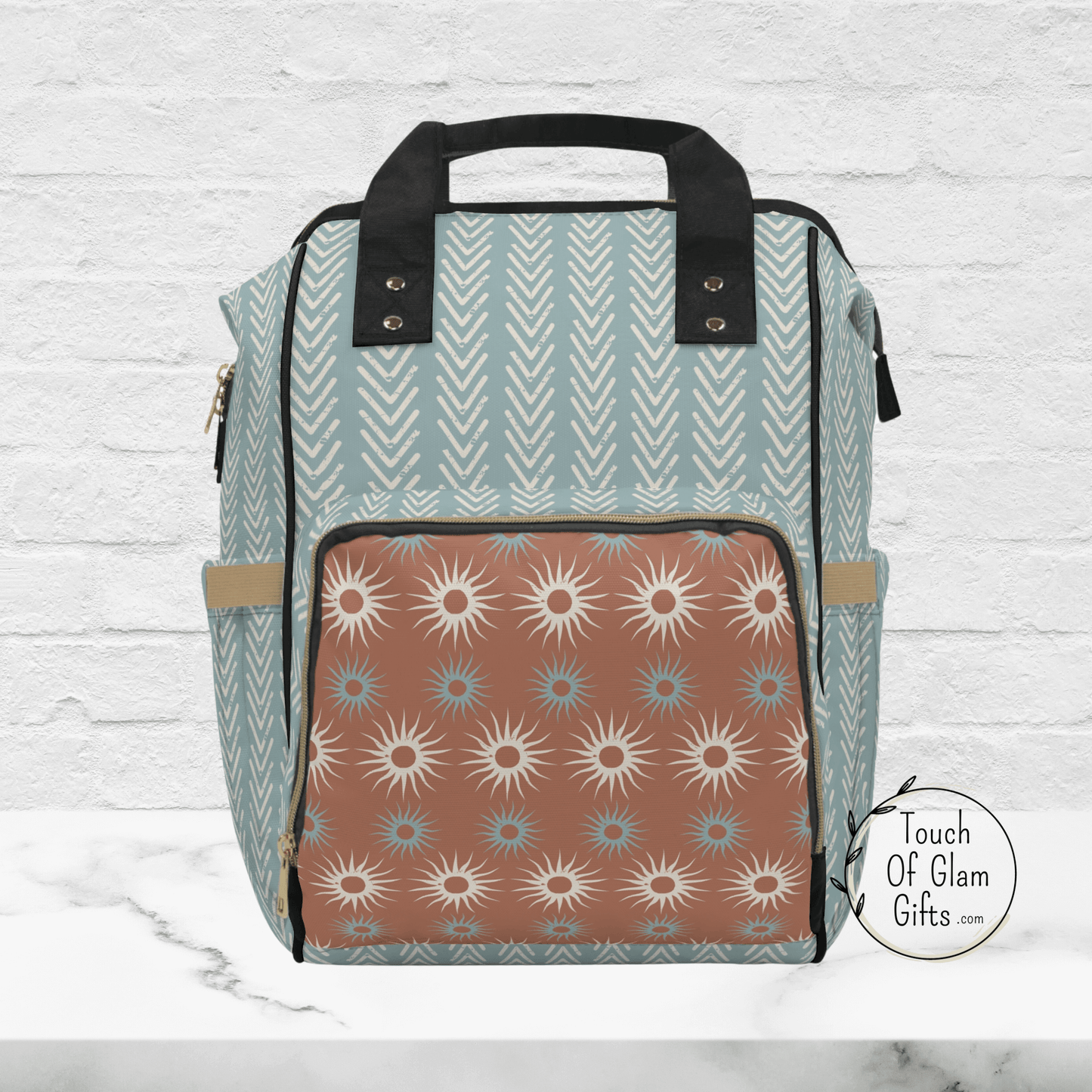 The boho diaper bag backpack is shown without the personalized monogramming. The boho sun designs on the exterior zippered pocket allows for more storage.