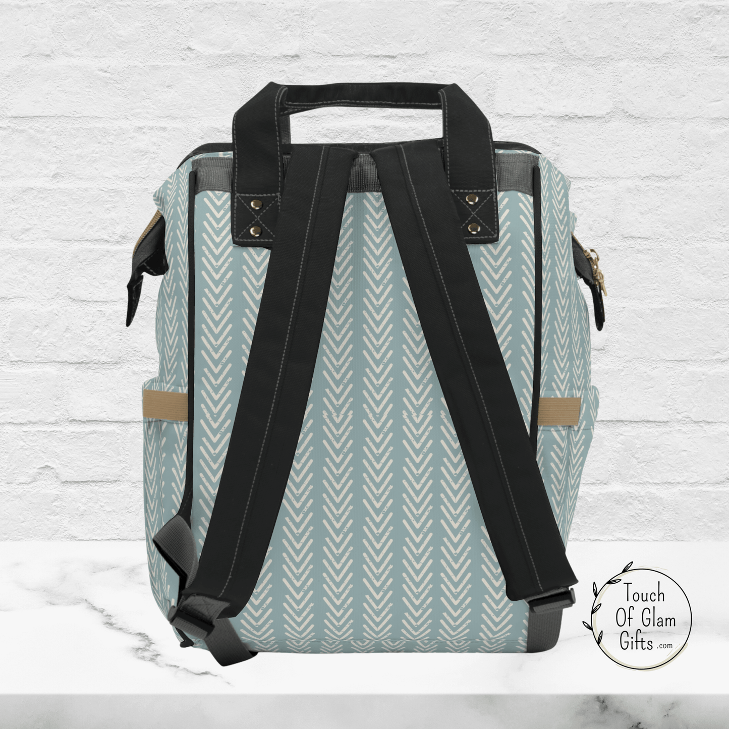 The back side of our boho diaper backpack for women shows the adjustable padded straps, the piping details and carrying handle are black. 