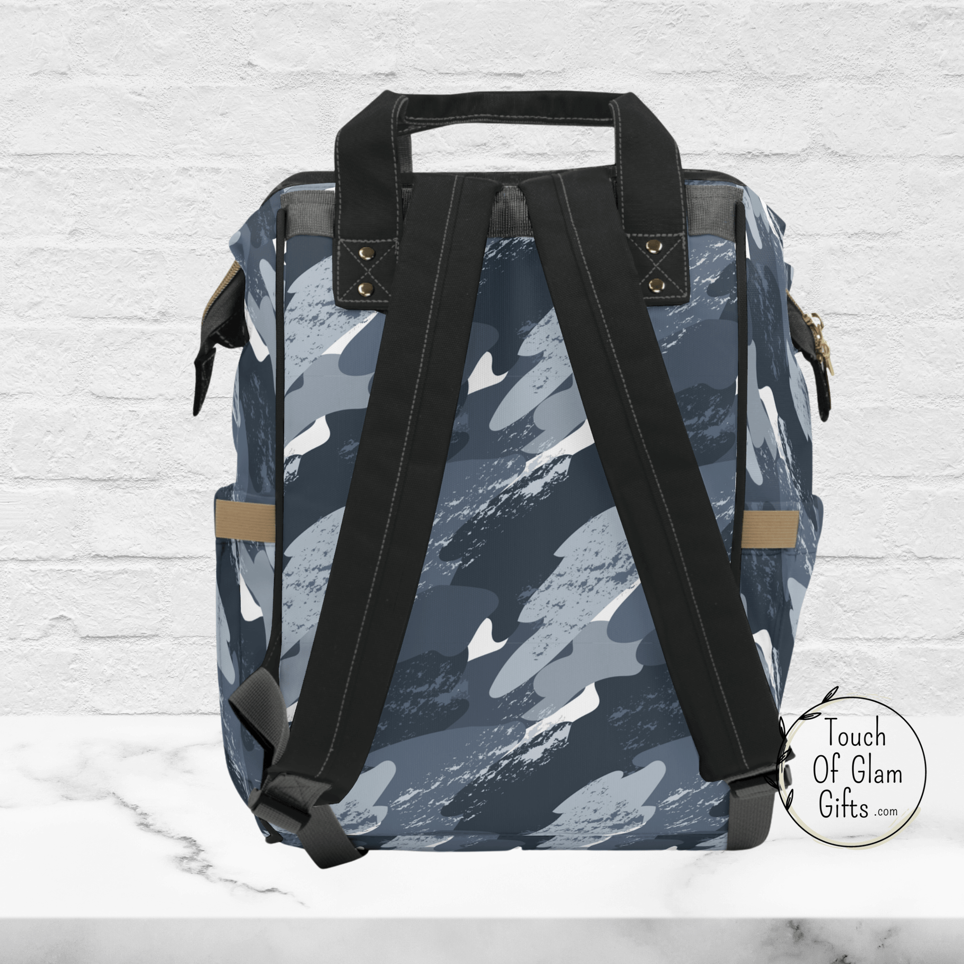 The back view of our dad life blue camo diaper bag shows the black adjustable, padded straps and black carrying handle on the top. This bag has details with black piping and is a large diaper backpack to hold kids stuff and a laptop too.