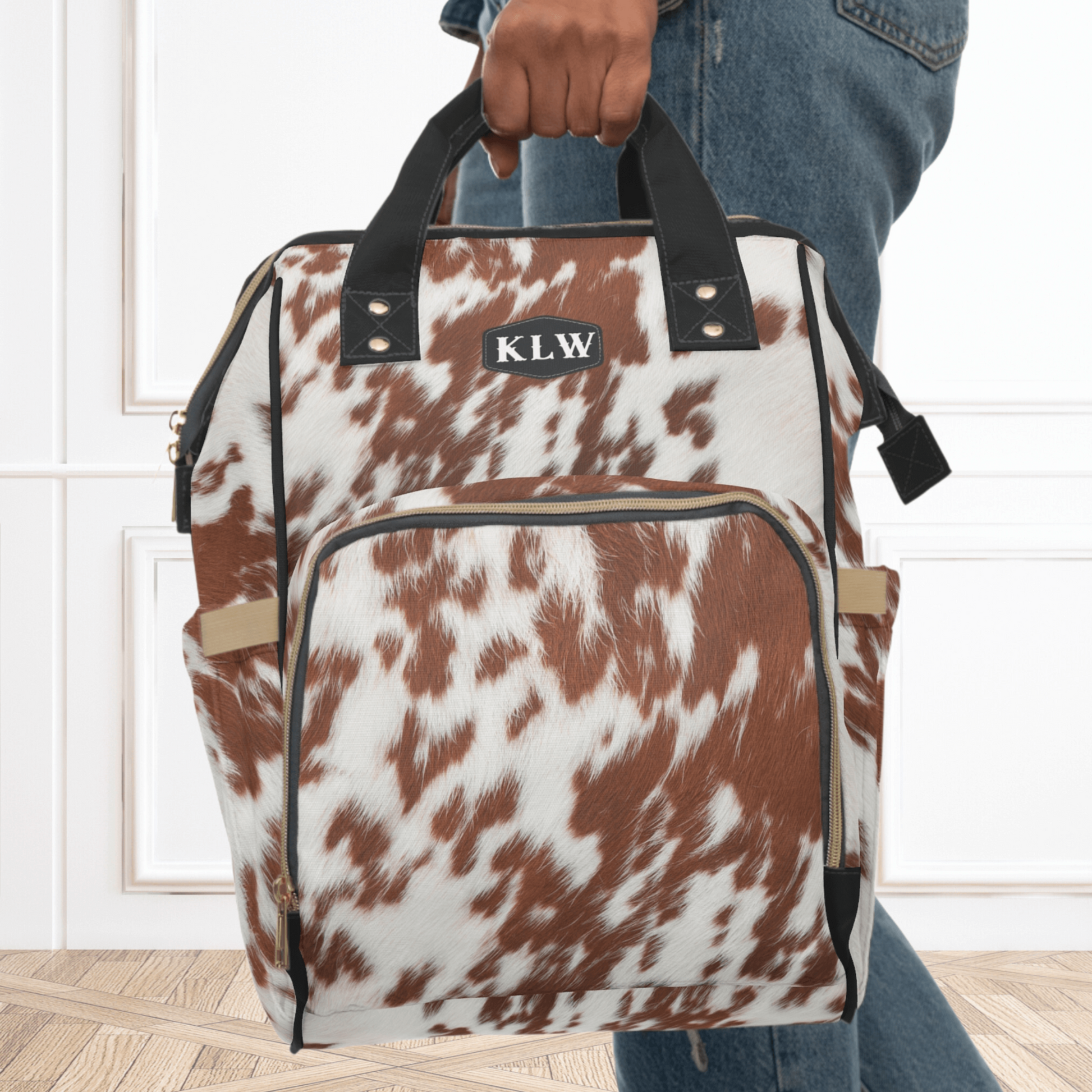This western diaper bag backpack can be carried with the handles and makes the perfect baby shower gift for mom. The cowhide is a print on canvas and can be easily washed.