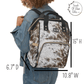 A female model is wearing the diaper backpack and we've inserted diagrams showing the size variances in inches. Height is fifteen inch, width is ten point eight inch and depth is six point seven inch.