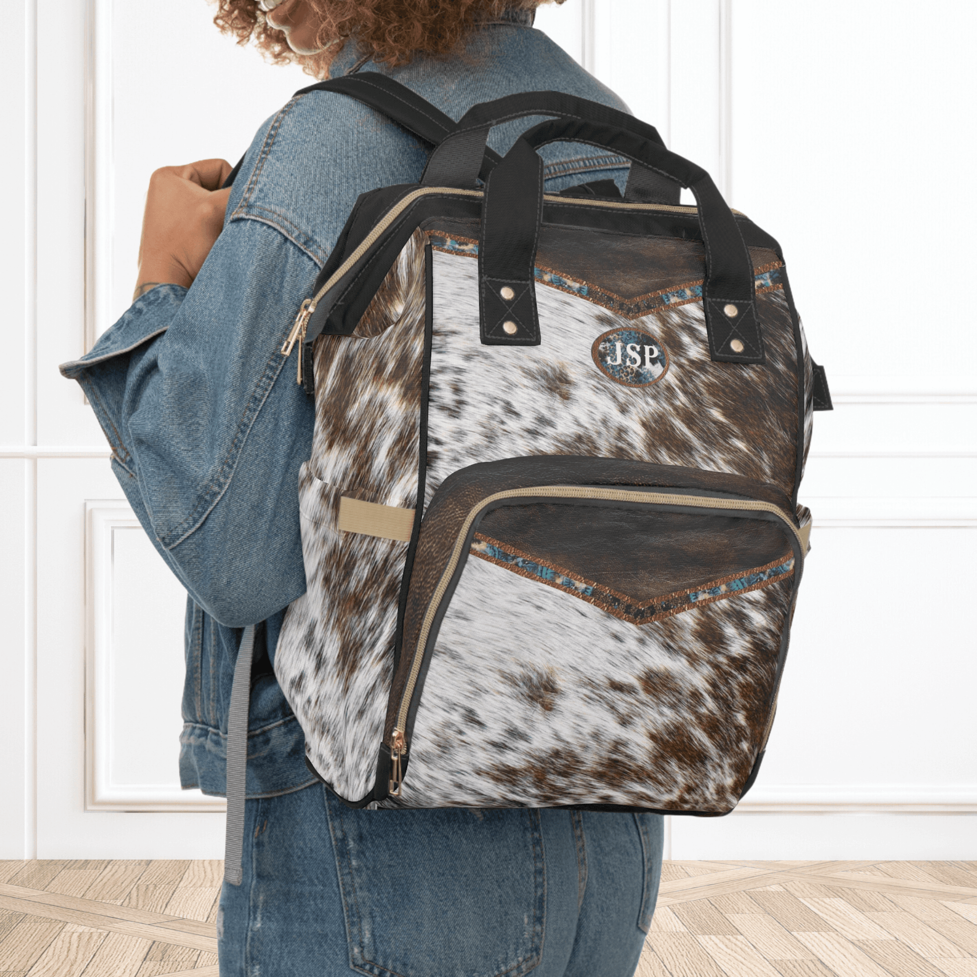 Our fancy cowhide and brown leather backpack is a print on durable nylon fabric so it looks like real cowhide but is just a print. This western travel bag makes the perfect personalized birthday gift for women that love to travel and be hands free