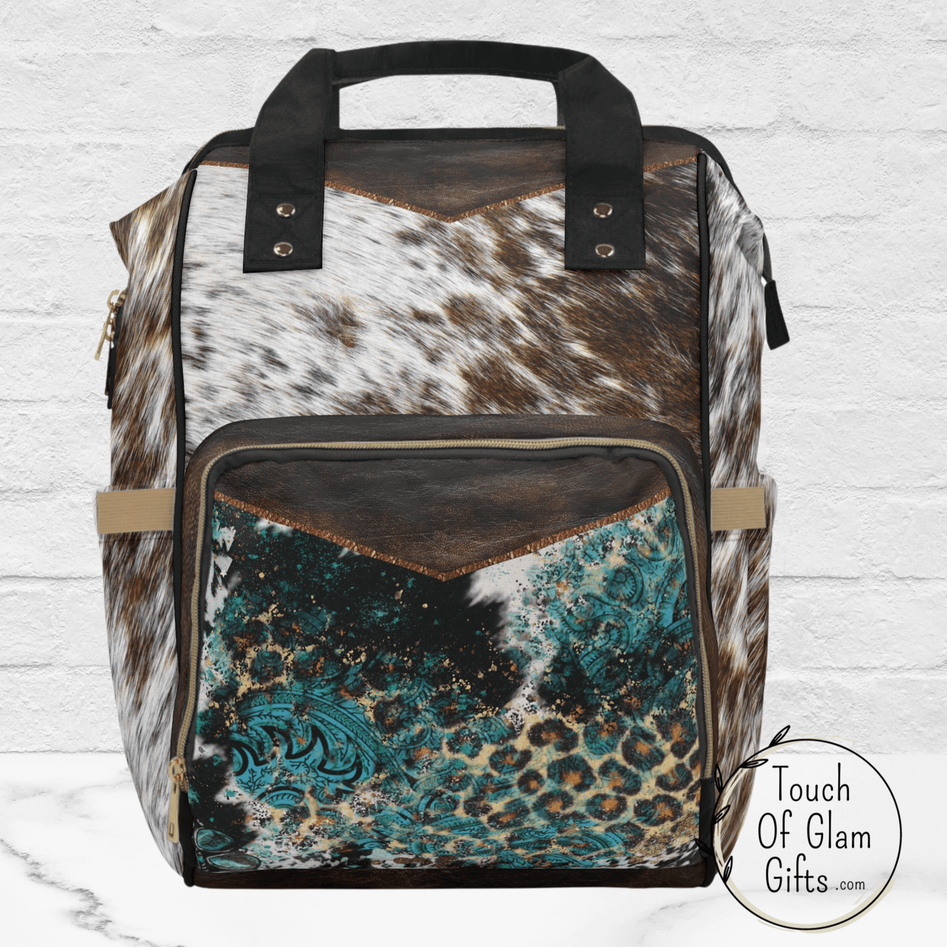 Our western style backpack can be customized or enjoyed plain, as shown here without monogramming. This cowhide print is highlighted with faux brown leather trim on the front and the base of the backpack.