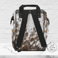 The back side of our diaper backpack shows a cowhide print with padded black shoulder straps and black carrying handles. The straps are adjustable and comfortable.