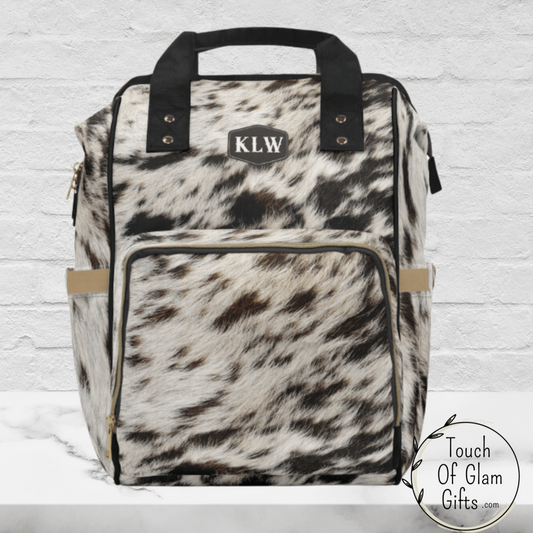 Our monogrammed cowhide two is a beautiful cow print on nylon diaper bag backpack with carrying handles. 