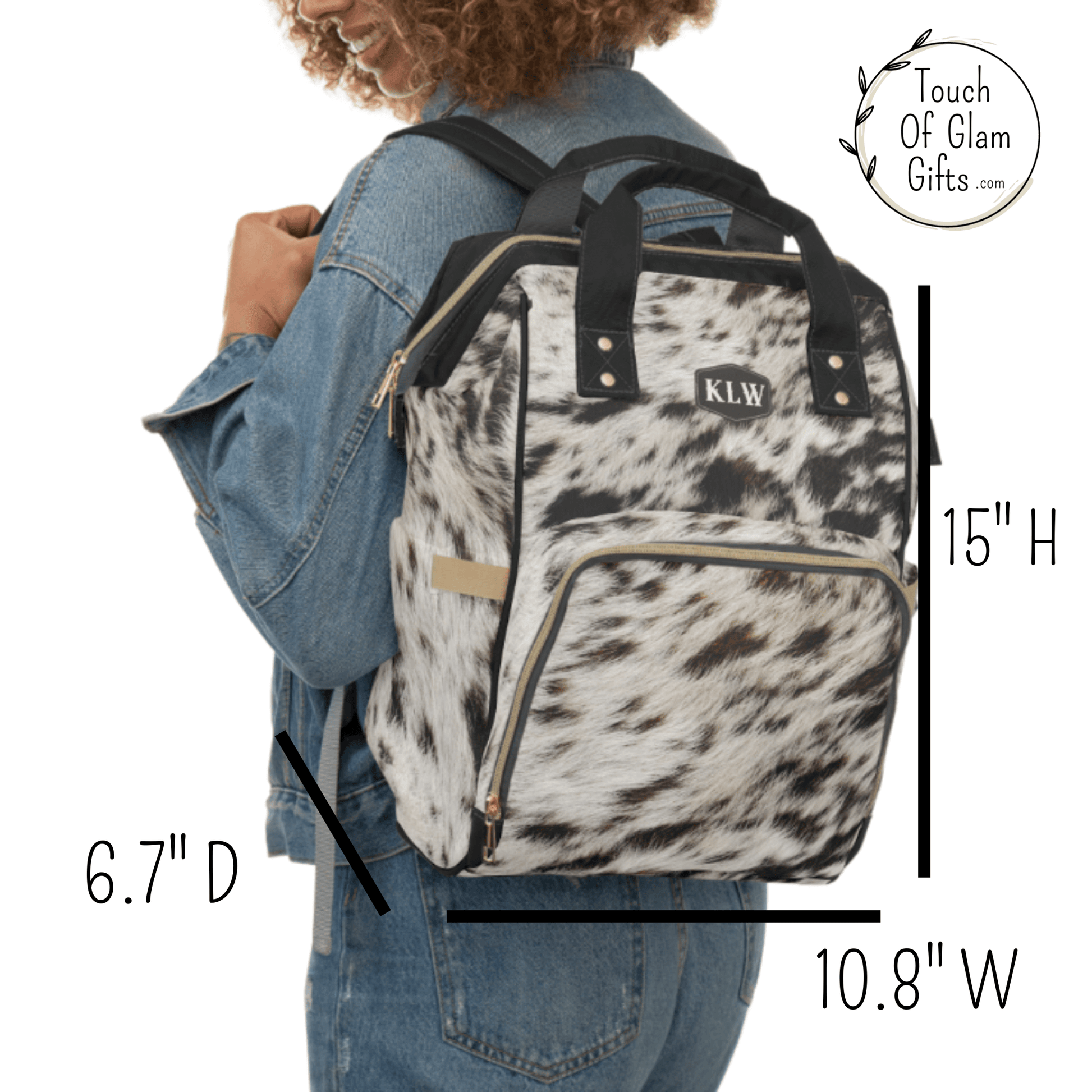 The cowhide backpack is shown on the back of a model with the height, width and depth measurements. 