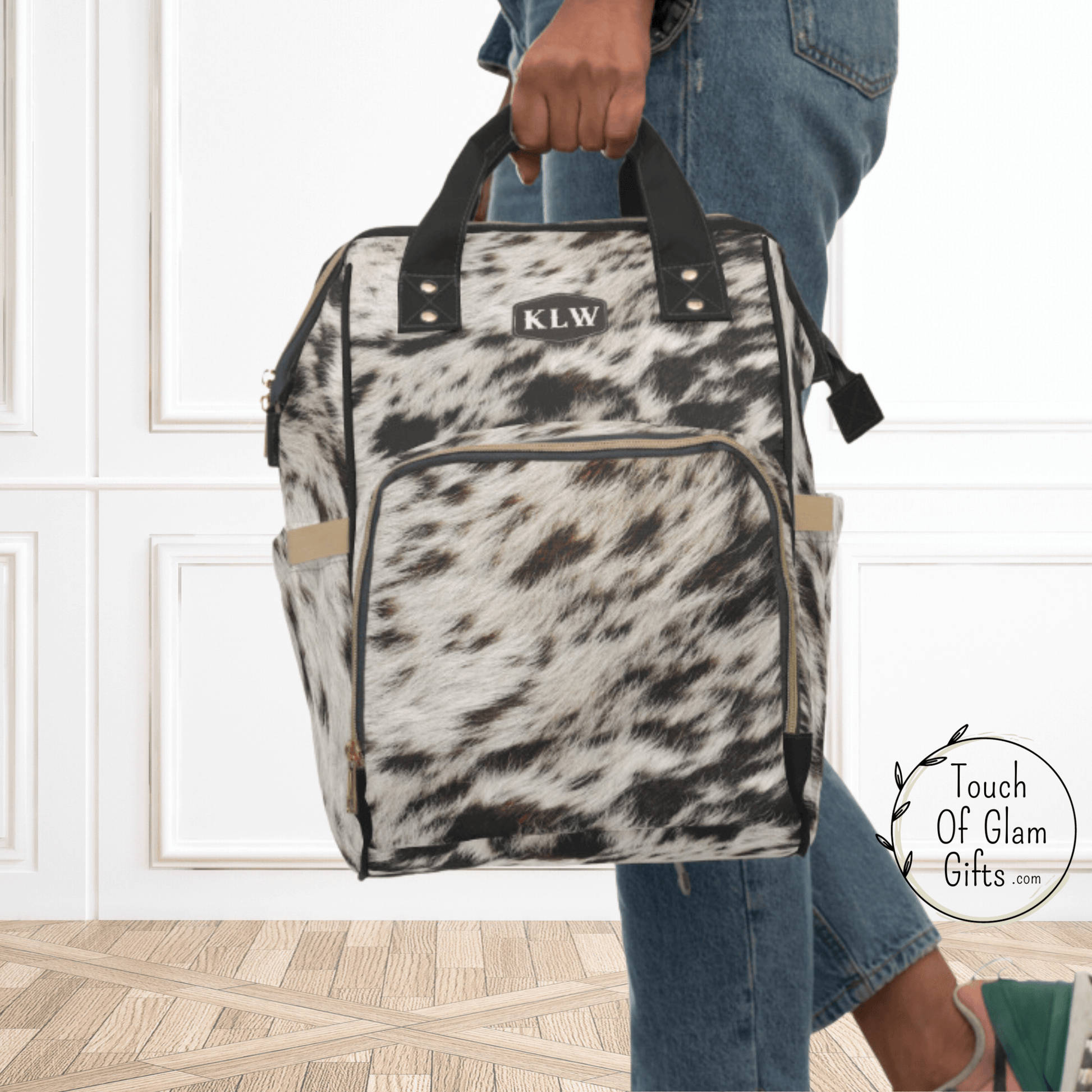 The cowhide backpack has large carrying handles for easy carrying capabilities.