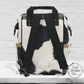 The back side of our cowhide print backpack has black and white cow print with black straps. THis diaper backpack is a great western gift for her.