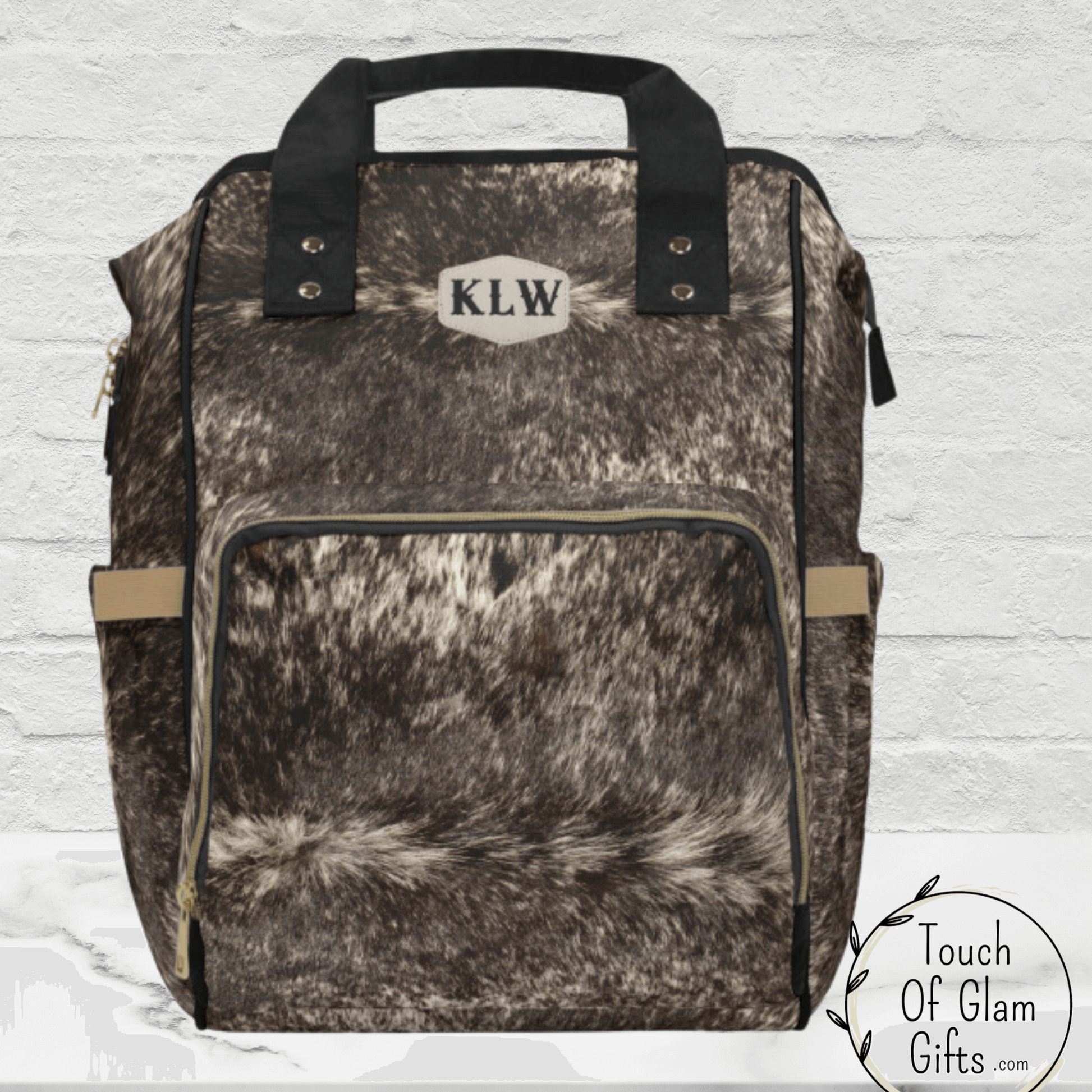 THis beautiful brown cowhide diaper bag can be monogrammed for the perfect baby shower gift or a gift for mothers day for moms with toddlers. 