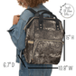 A model is wearing our western style backpack and the measurements show height is fifteen inches, width is ten point eight inches and depth is six point seven inches.