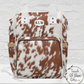 Our rust and white cowhide diaper backpack can be monogrammed or left plain. THis bag is multipurpose and can be carried by handles or over the shoulder like a backpack.