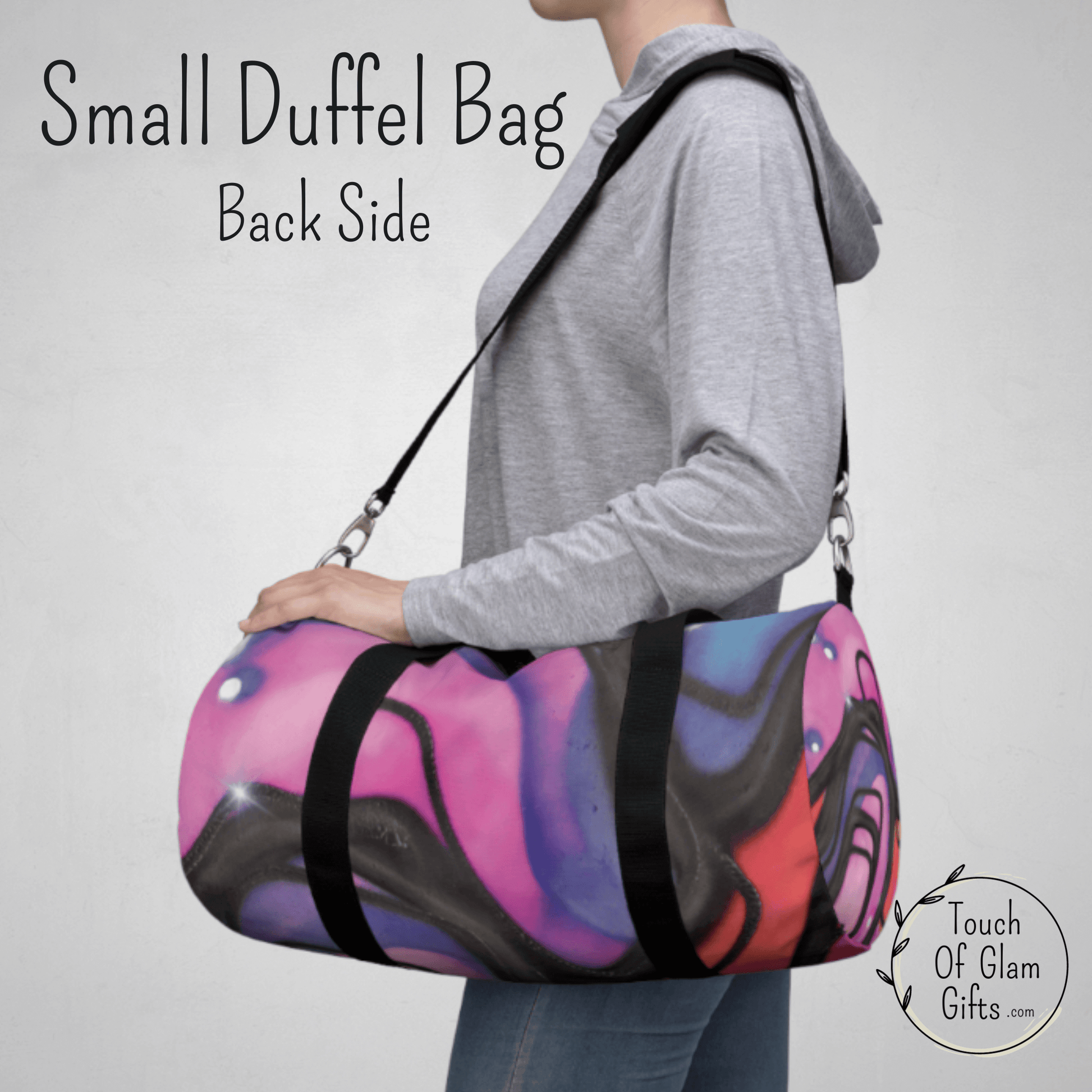 a female model has the small pink retro duffel bag with the padded shoulder strap to show the size of the small weekender bag for teen girls.