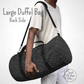 A male model with our dark grey duffel bag with black straps and metal hardware over his shoulder with the padded shoulder strap.