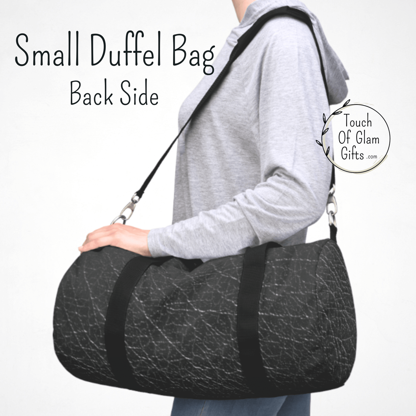 A woman wearing the charcoal grey and black canvas duffel bag to show the size. 