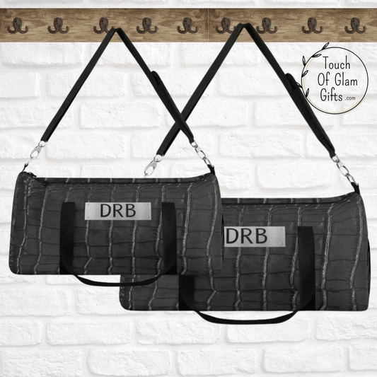 Our grey and black snakeskin duffel bag for men and women is shown with the two size choices in large and small. 