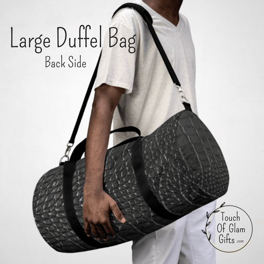A made model has the large black snakeskin duffel bag, made of canvas, over his shoulder to show the size of the bag.