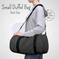 Our small duffel bag is shown on a female model to show the size of the black duffel bag with shoulder strap.