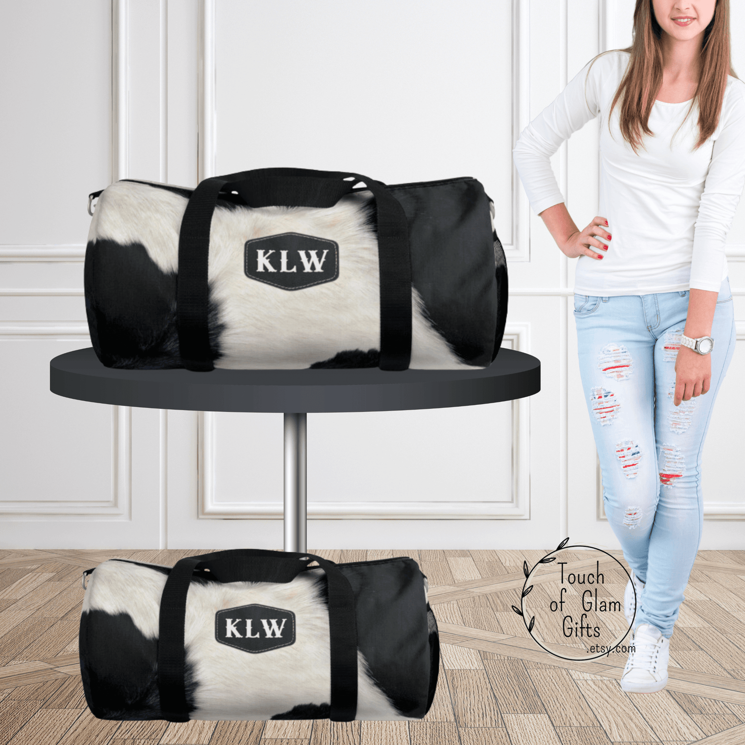 Our black and white cowhide print duffel bag is shown with monogrammed initials on the bag. The duffel bag is canvas with a cow print and can be ordered in large or small size bag.