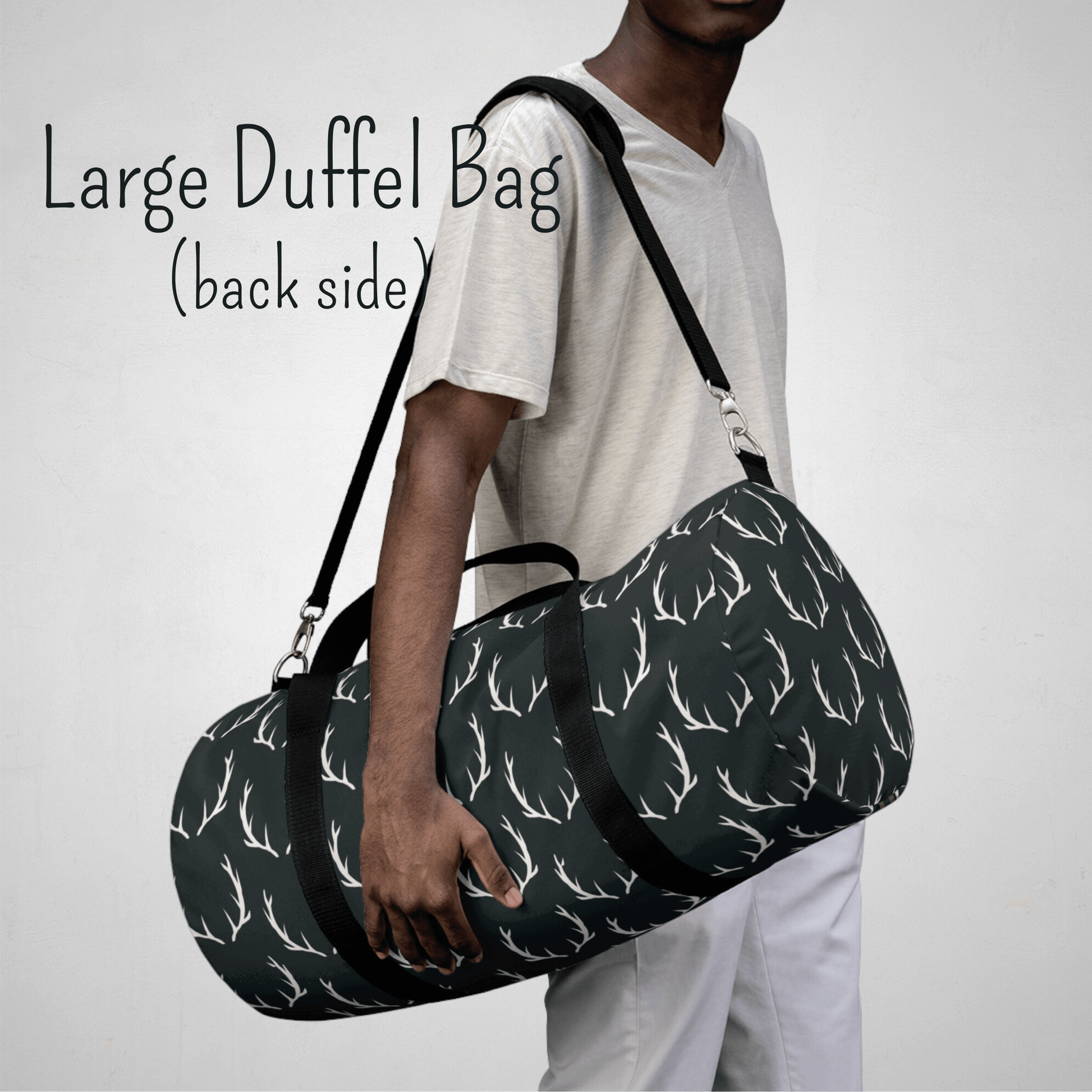 Our large duffel bag with deer antlers is shown on a model. This bag can be carried over the shoulder with the padded strap or with the black carrying handles. This bag is large size.