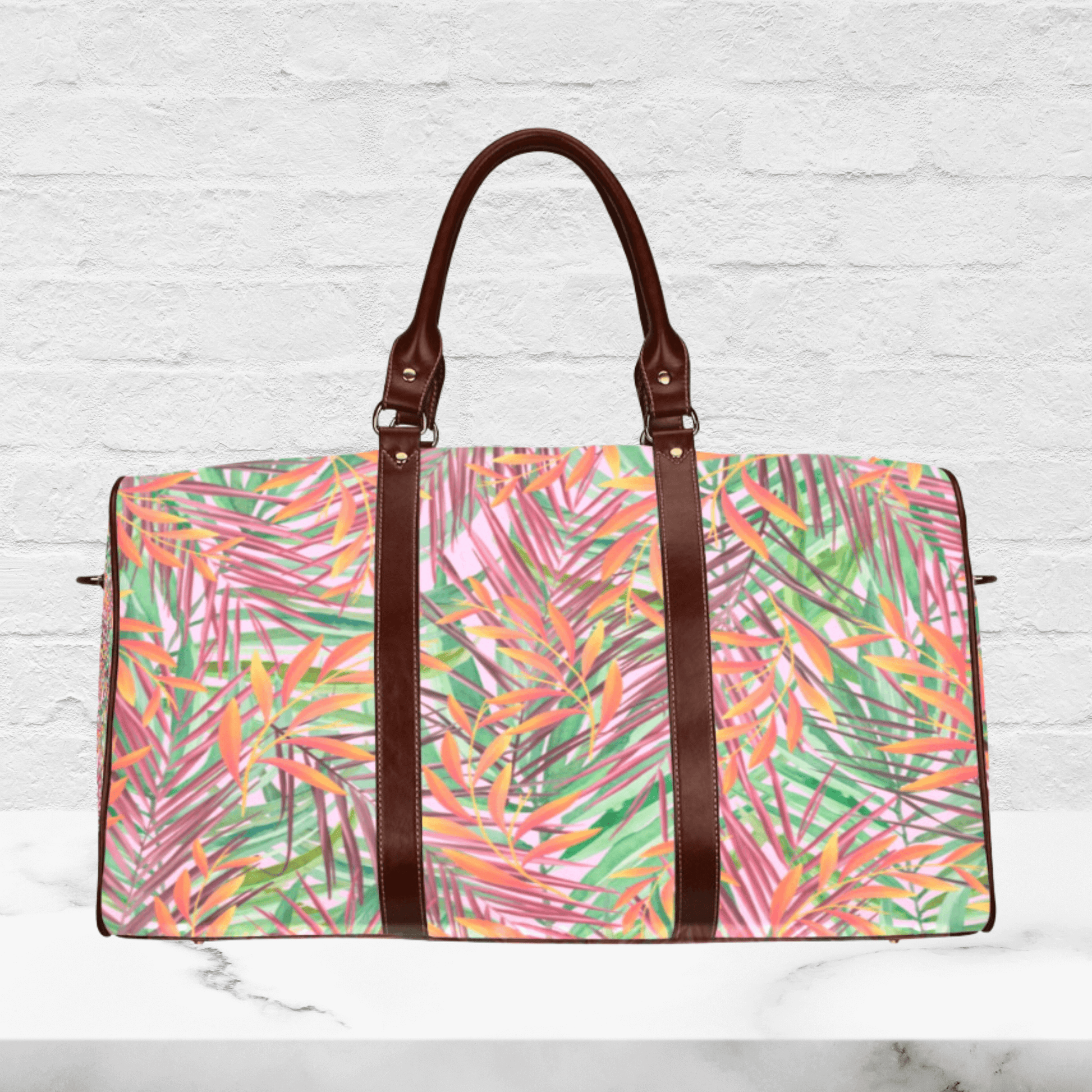 Our custom tropical vibe weekender bag has faux brown leather handles and stylish straps.