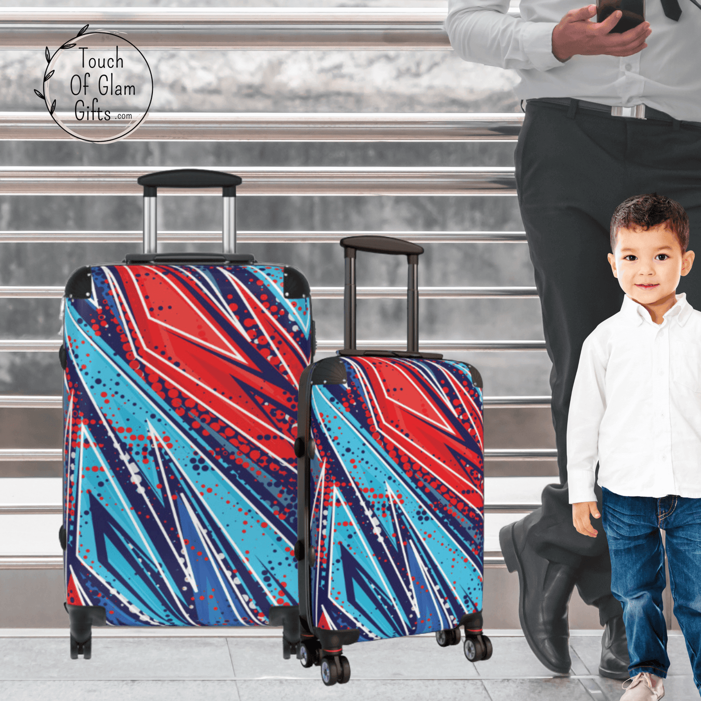 A little boy is standing next to his medium suitcase and small suitcase with wheels. 