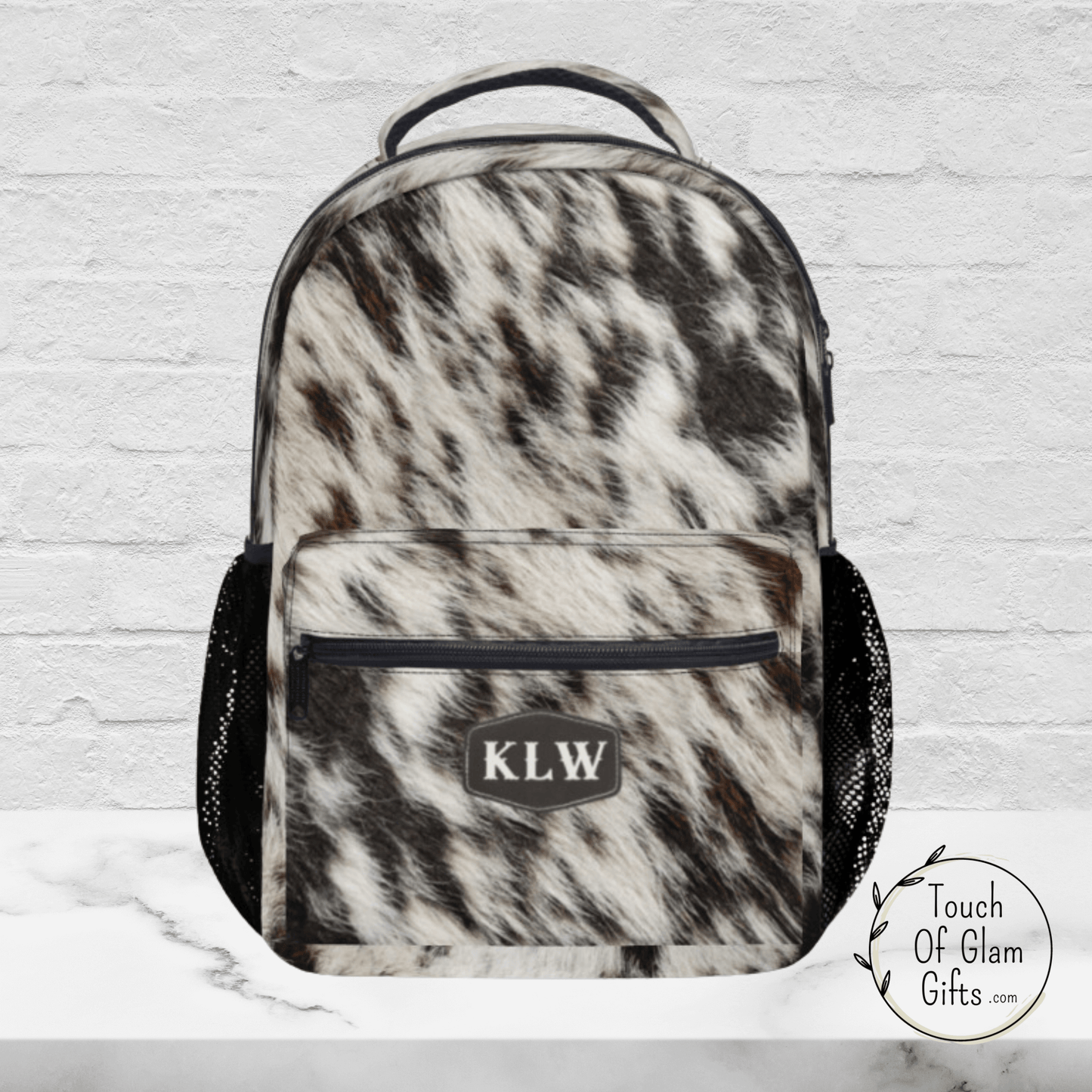 Our monogrammed cow print backpack.