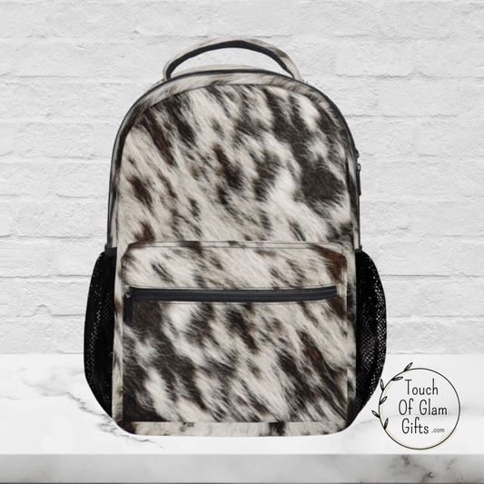 This western cow print backpack is sturdy and durable for traveling. You can get it plain like this one or with monogram initials.