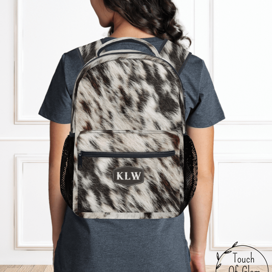 OUr cow print monogrammed backpack is a custom item and there's no other backpack like it. The perfect western travel bag.