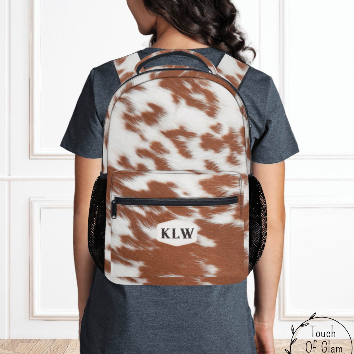 our rust spotty cowhide backpack with monogrammed initials.