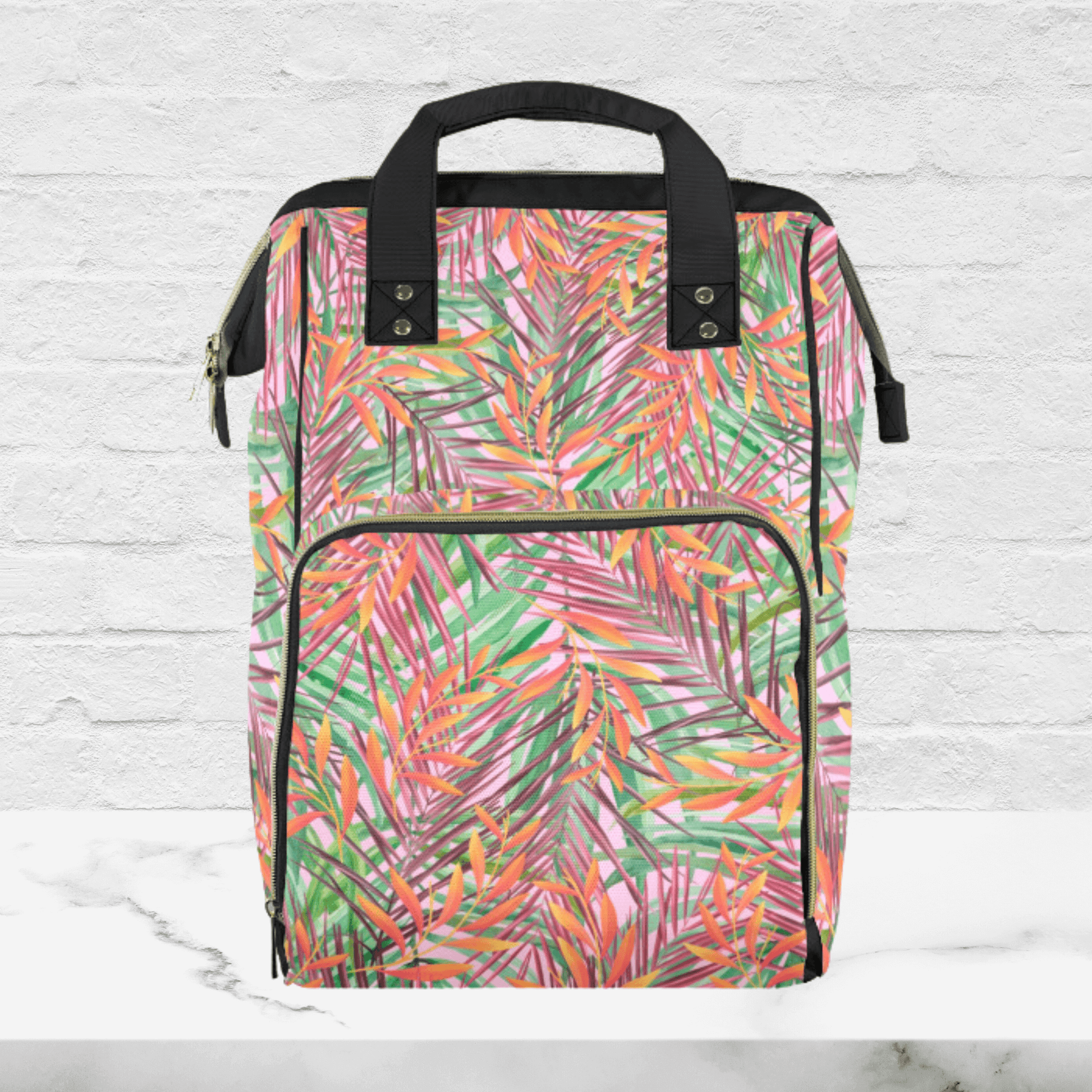 Our summer tropical island leaves diaper bag is the perfect colorful bag this summer. The orange, green and pink leaves are a fun addition to any outfit.