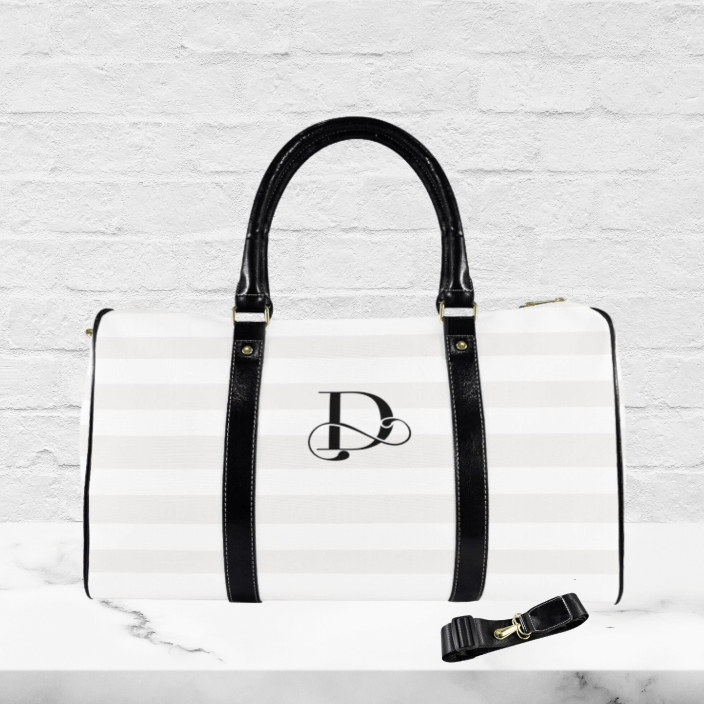 OUr elegant duffel bag for women is this classy stripped and monogrammed flight bag with black handles.