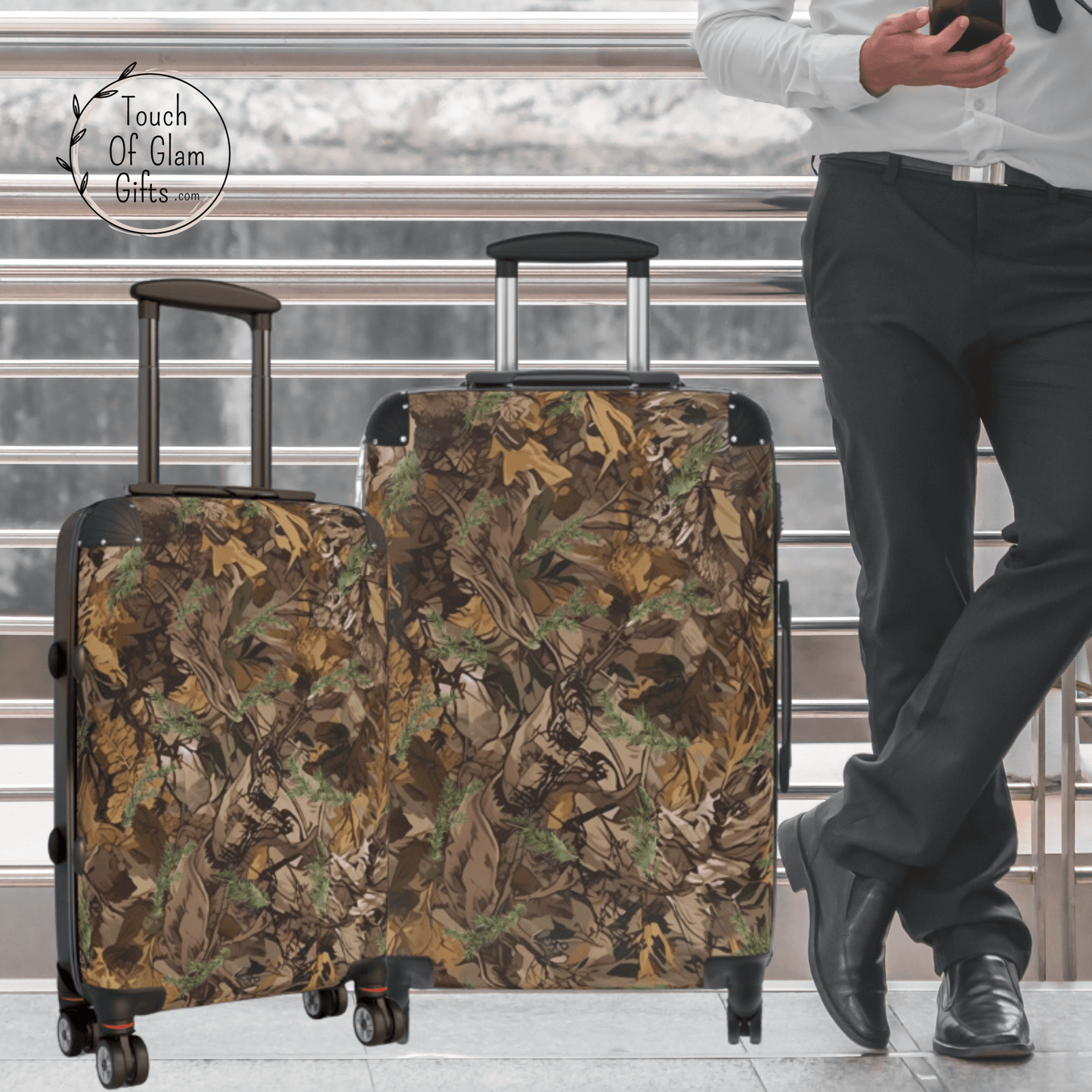 A guy standing next to his camo luggage in the small carry on and medium camo suitcase with no personalization.
