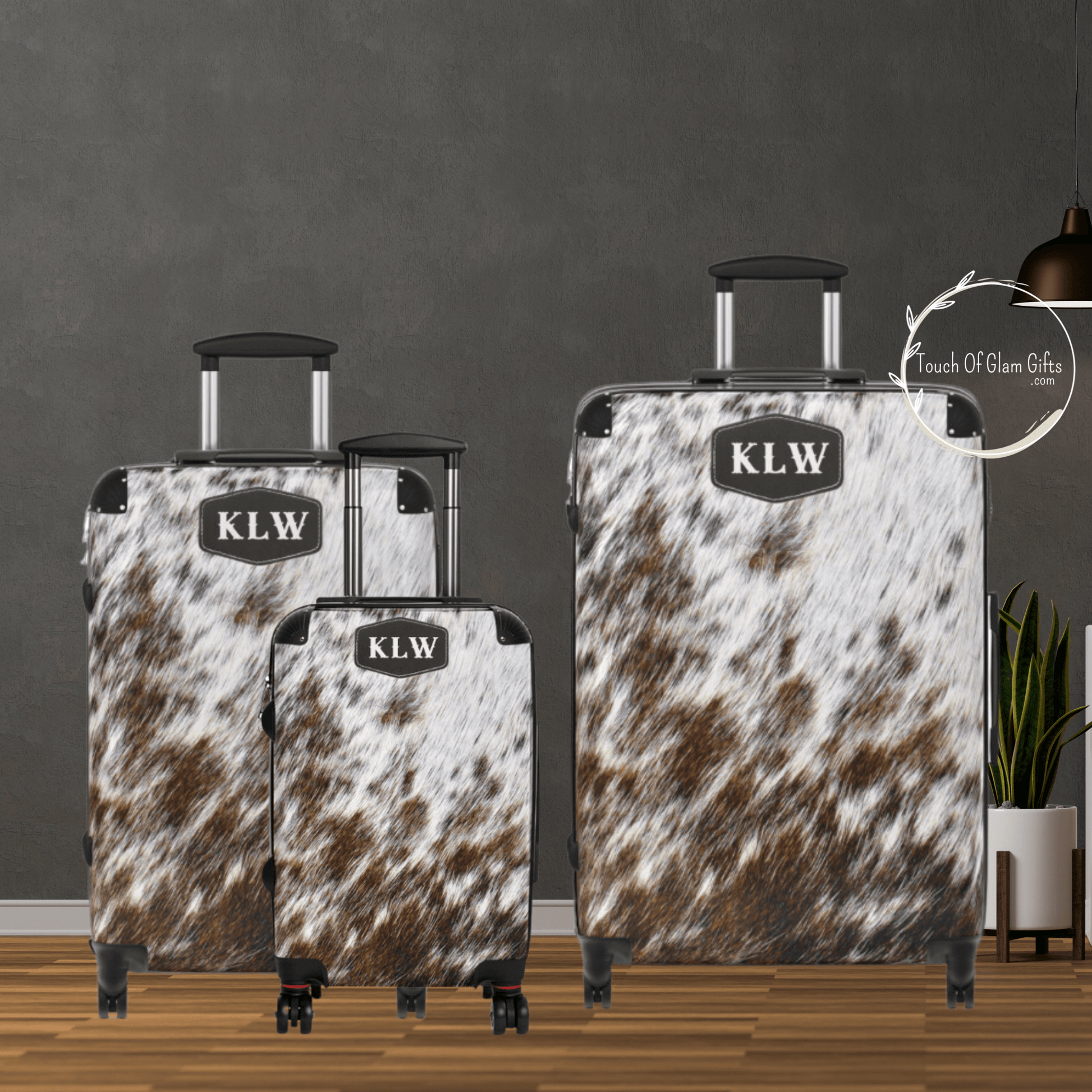 a dark wall backdrop really makes this light off white cowhide with brown spots really pop. This luggage set has the leather patch with 3 initials for a customized luggage look.
