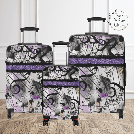 Three piece set of luggage with purple and musical notes. The musical lover would love this luggage to travel with.